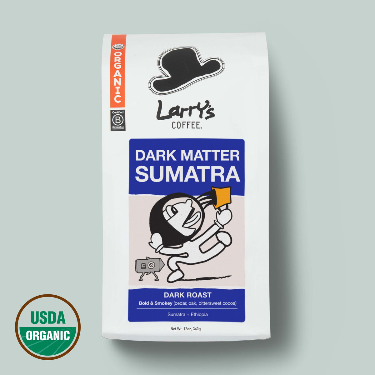 A bag of Larry's Coffee Dark Matter Sumatra dark roast coffee on a light gray background, featuring a white bag with blue and orange label blocks and a USDA Organic seal in the lower left corner.