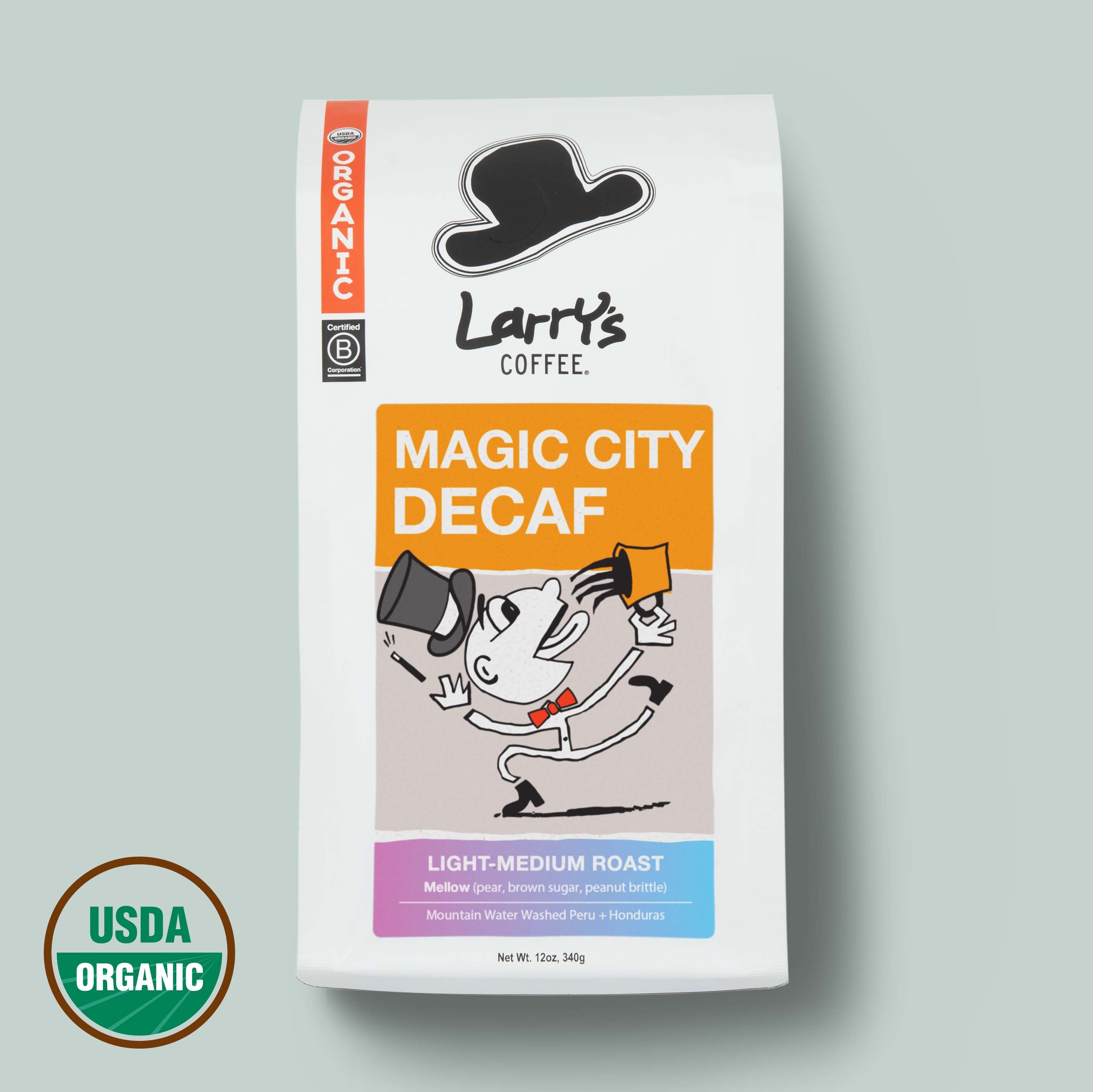 A bag of Larry's Coffee Magic City Decaf on a light gray background, featuring a white bag with orange, black, and blue label accents, alongside a USDA Organic seal.